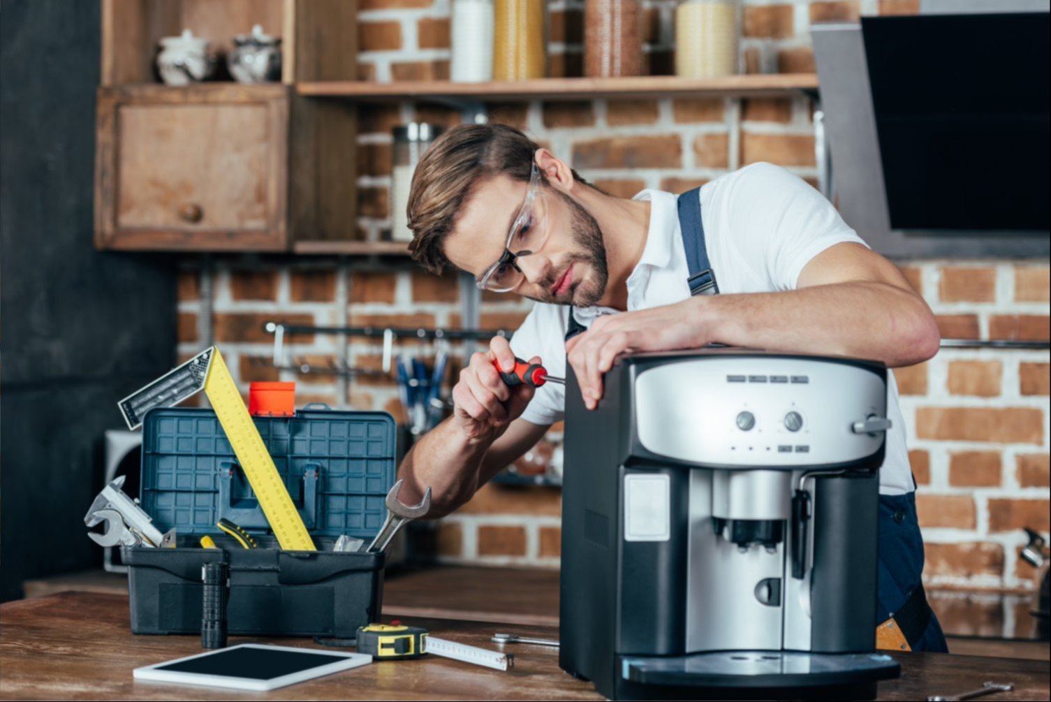 A home espresso machine producing a shot of coffee on a kitchen worktop